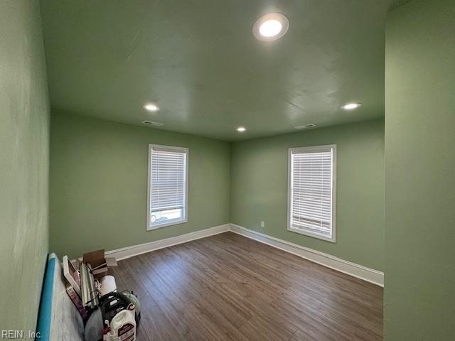 unfurnished room with dark hardwood / wood-style flooring