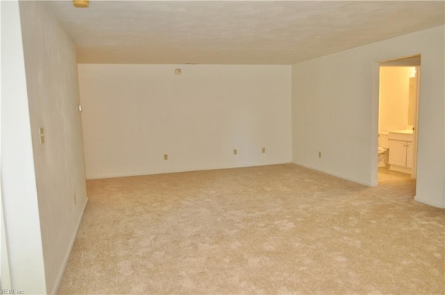 unfurnished room with light carpet