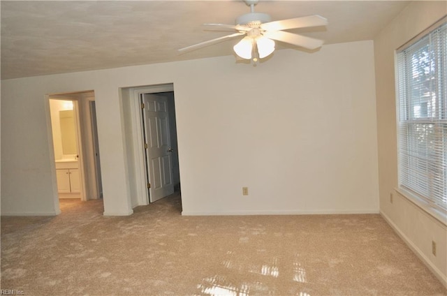 empty room with ceiling fan and light colored carpet