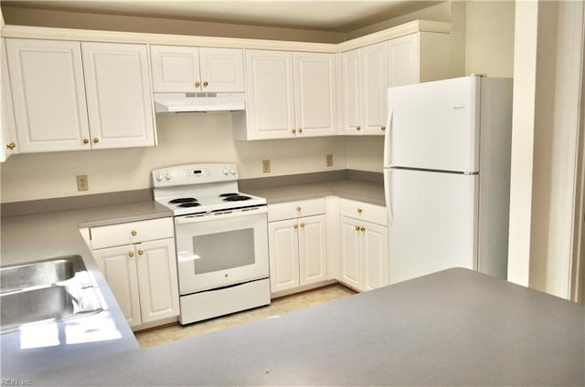 kitchen featuring white appliances, sink, and white cabinets