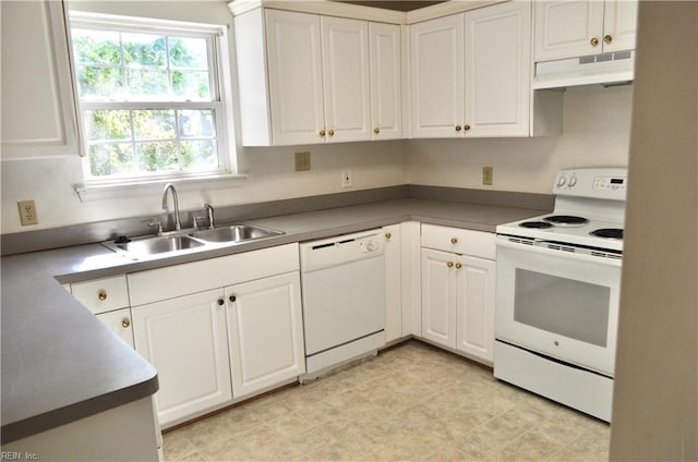 kitchen featuring sink, white appliances, and white cabinetry