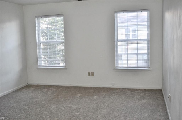 empty room featuring carpet floors and plenty of natural light