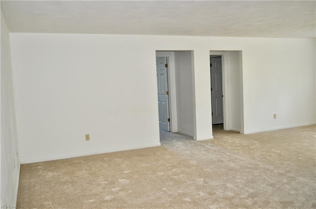 spare room featuring light colored carpet