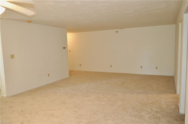 spare room featuring light colored carpet