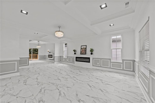 unfurnished living room with ornamental molding, beamed ceiling, and a chandelier