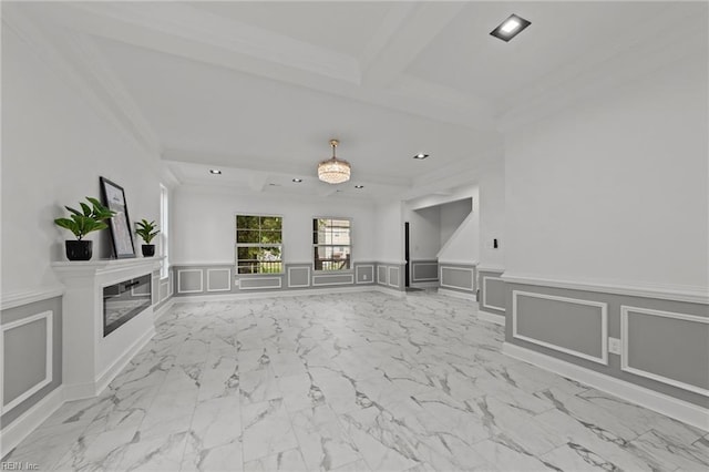 unfurnished living room with ornamental molding and beamed ceiling