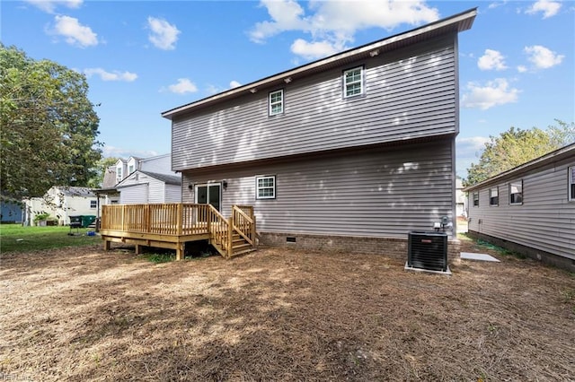 back of property with a wooden deck and central AC