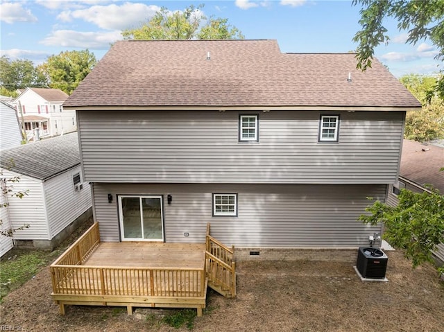 rear view of house with a deck and central AC unit