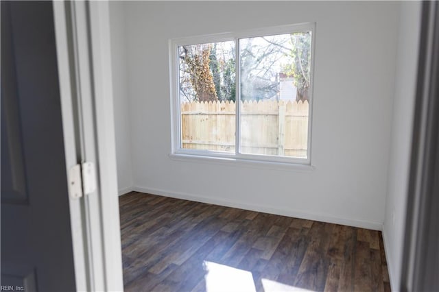 unfurnished room featuring dark wood-type flooring