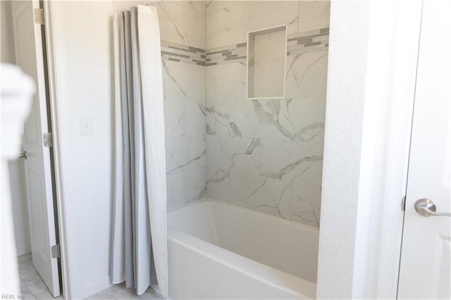 bathroom with shower / tub combo with curtain