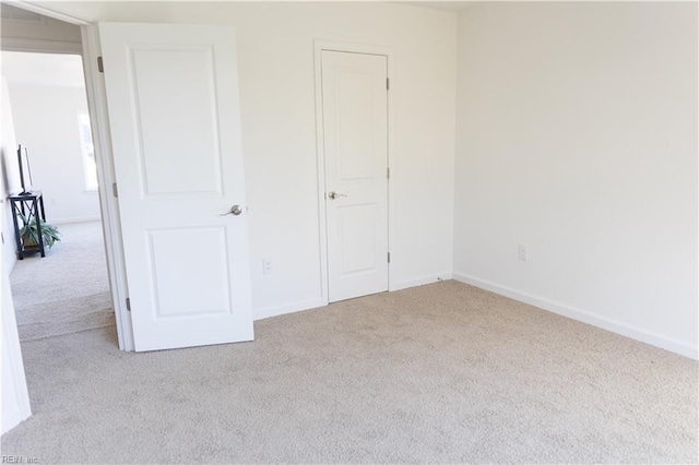 unfurnished bedroom with light colored carpet