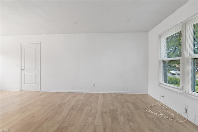 empty room featuring light hardwood / wood-style floors and a healthy amount of sunlight