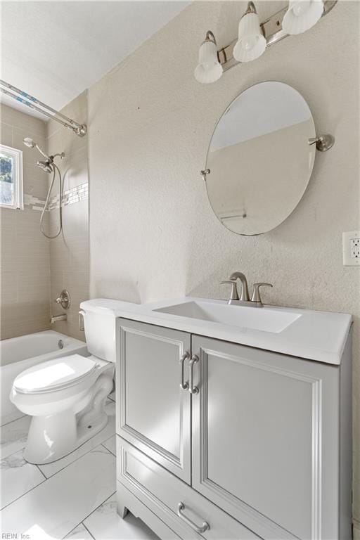 full bathroom featuring toilet, vanity, and tiled shower / bath