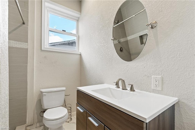 bathroom with toilet, walk in shower, and vanity