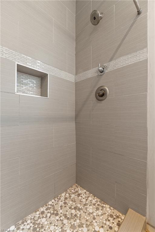 bathroom with tiled shower