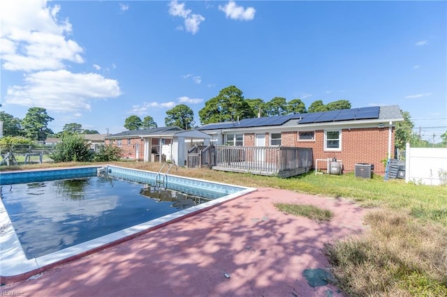 view of swimming pool featuring central AC and a wooden deck