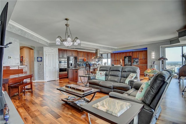 living room featuring crown molding, hardwood / wood-style floors, and a wealth of natural light