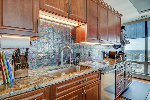 kitchen with light hardwood / wood-style floors, dishwasher, light stone countertops, and sink