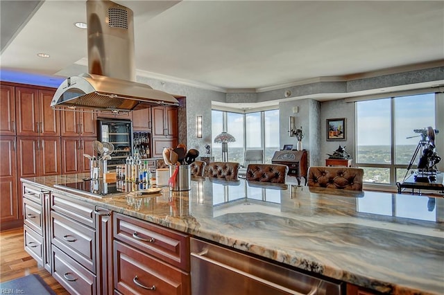 kitchen featuring island range hood, light stone countertops, light hardwood / wood-style flooring, and black appliances