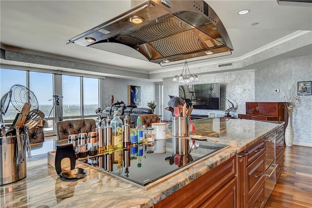 kitchen featuring extractor fan, crown molding, decorative light fixtures, dark hardwood / wood-style floors, and black electric stovetop