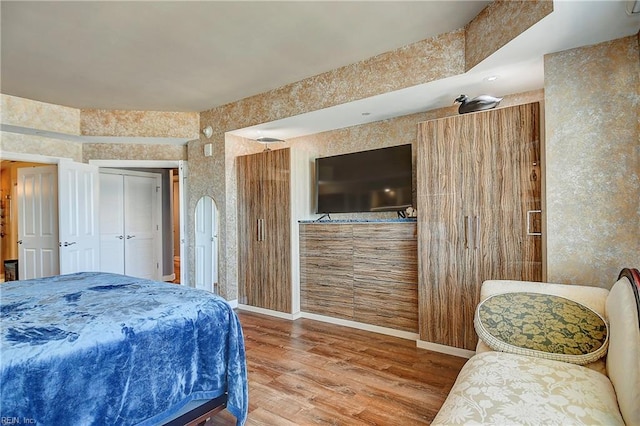 bedroom with a closet and hardwood / wood-style flooring