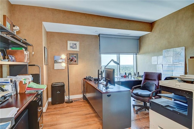 office area featuring light wood-style floors and baseboards