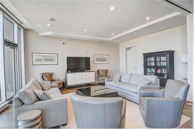 living room featuring a raised ceiling