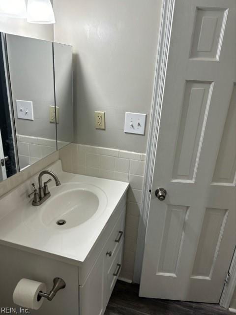 bathroom with tile walls and vanity