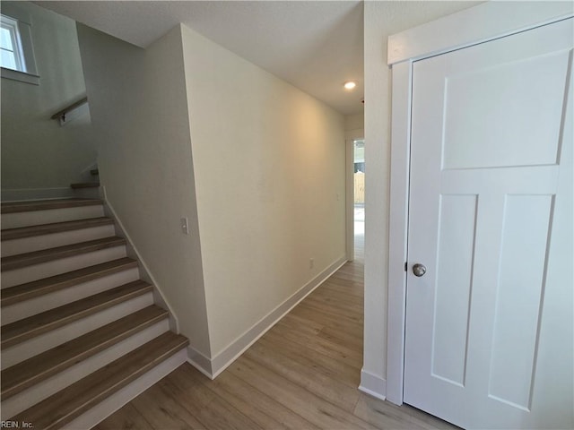 stairway featuring wood-type flooring