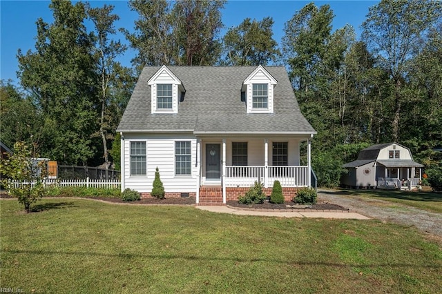 cape cod house with a front yard and covered porch