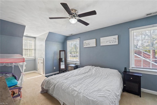 carpeted bedroom with ceiling fan, lofted ceiling, and multiple windows