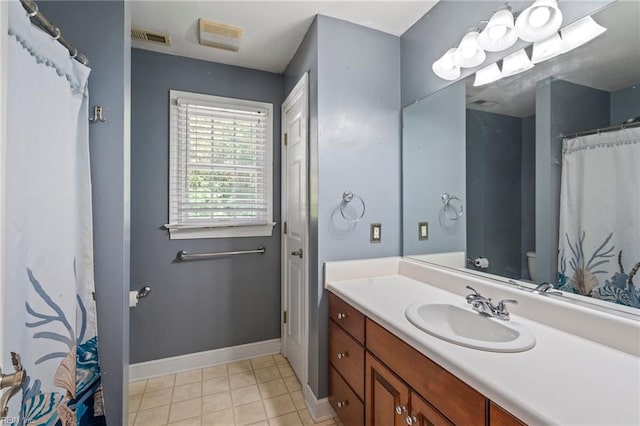 bathroom with tile patterned floors, vanity, and toilet