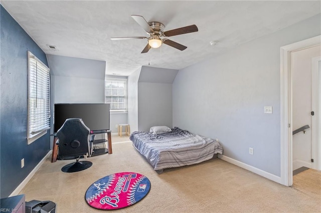 carpeted bedroom featuring vaulted ceiling and ceiling fan