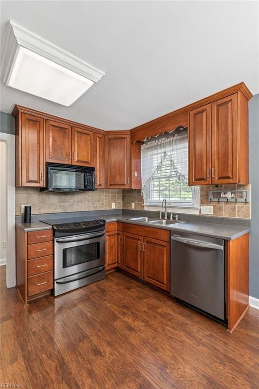 kitchen with stainless steel appliances, dark hardwood / wood-style floors, backsplash, and sink