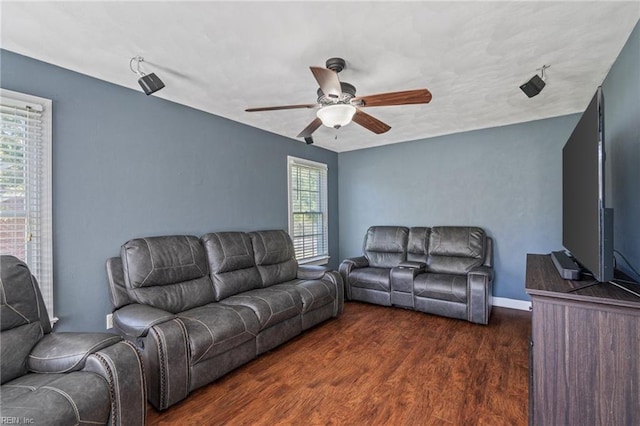 living room with plenty of natural light, dark hardwood / wood-style floors, and ceiling fan