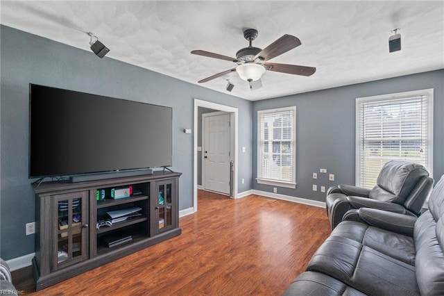 living room featuring ceiling fan and hardwood / wood-style floors