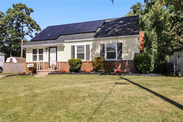 back of house featuring a shed, a yard, and solar panels