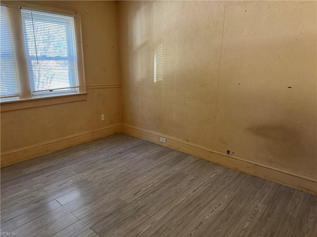 unfurnished room with hardwood / wood-style flooring