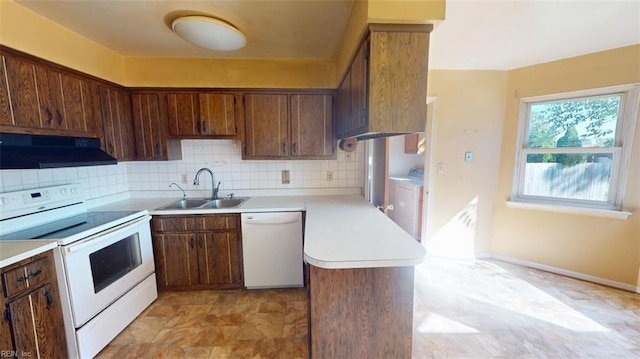 kitchen featuring white appliances, washer / dryer, sink, backsplash, and ventilation hood