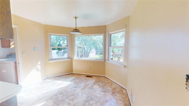 unfurnished dining area featuring washer / dryer