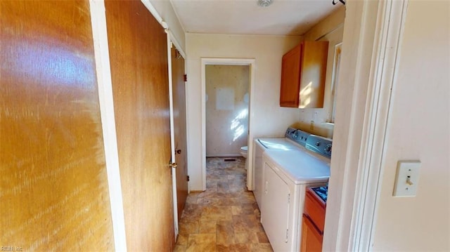 laundry room featuring independent washer and dryer and cabinets