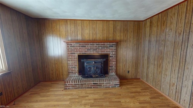 unfurnished living room featuring wooden walls and light wood-type flooring