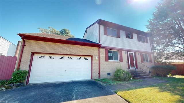 view of front of home featuring a front lawn and a garage