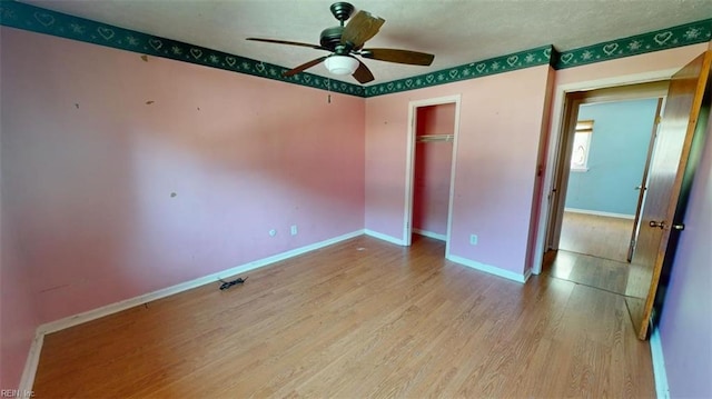 unfurnished bedroom with a closet, ceiling fan, and light hardwood / wood-style flooring