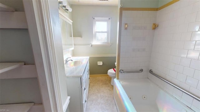 bathroom with vanity, a bathtub, toilet, and tile patterned floors