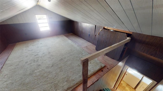 additional living space featuring wood ceiling, wood walls, carpet, and vaulted ceiling