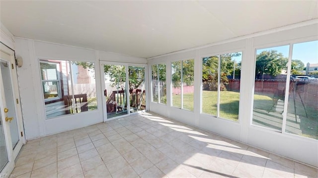 unfurnished sunroom with vaulted ceiling and a wealth of natural light