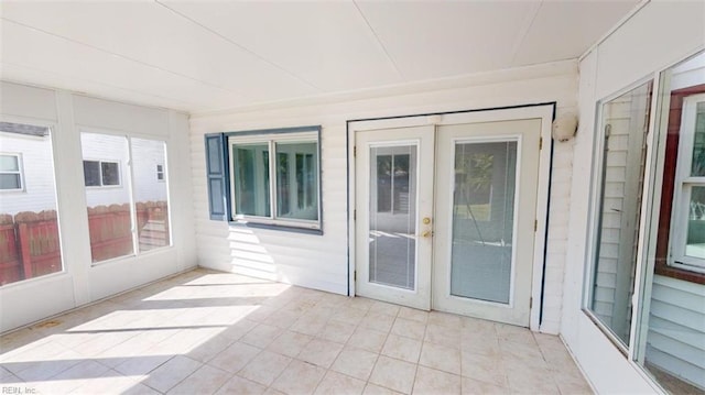 unfurnished sunroom with french doors