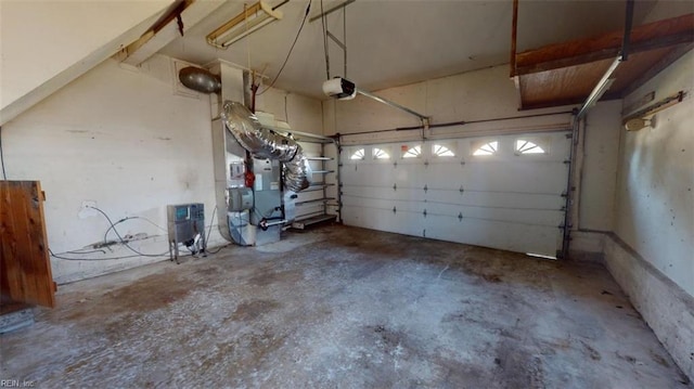 garage featuring a garage door opener and heating unit