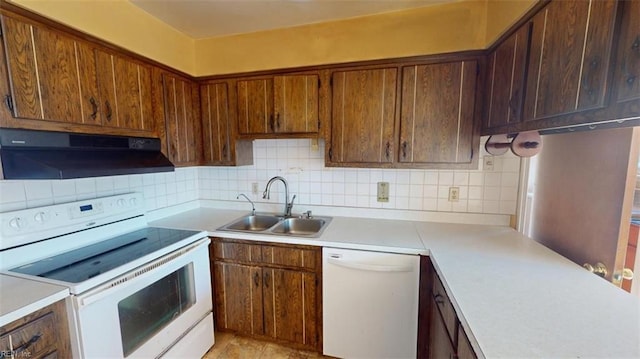 kitchen featuring white appliances, backsplash, and sink